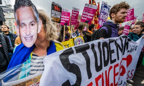 A woman wears a Gary Lineker mask at a pro-refugee rally in London on 18 March 2023.