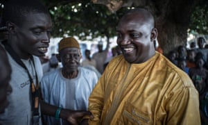 Adama Barrow is greeted by supporters in Jambur.