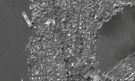 A satellite image shows flooded homes along Dnipro River southeast of Kherson, Ukraine, June 6, 2023.