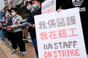 Medical workers hold a strike near Queen Elizabeth Hospital, demanding Hong Kong close its border with China to reduce the coronavirus spreading.