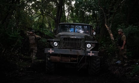 Ukrainian soldiers park a Grad missile truck at a hidden location in the forest in Donetsk province
