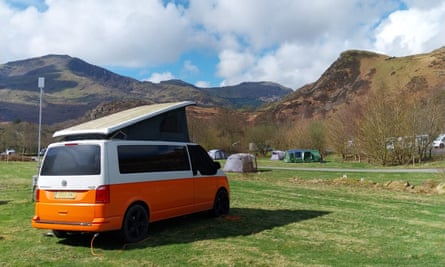 An orange and white campervan at Cae Du campsite.