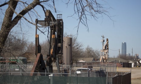 Oil field pumping rigs stand in an Oklahoma City neighbourhood. Many believe the injection into deep underground wells of fluid byproducts from drilling operations is causing earthquakes.
