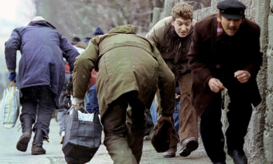 Residents of Sarajevo run for cover