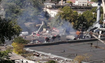 Smoke rises from a damaged ship.