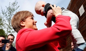 Scotland’s first minister, Nicola Sturgeon, holds a baby while out campaigning in Edinburgh.
