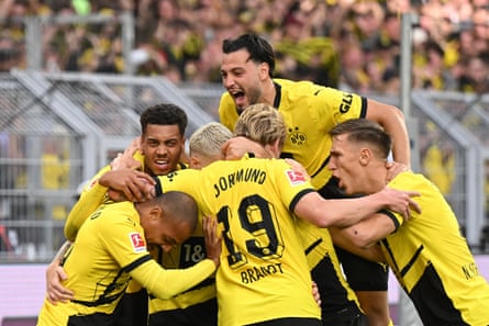 Dortmund’s Marco Reus is mobbed after scoring.