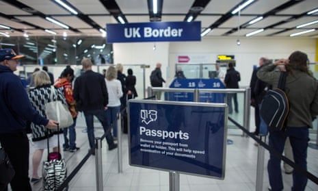 Border Force check the passports of passengers arriving at Gatwick Airport.