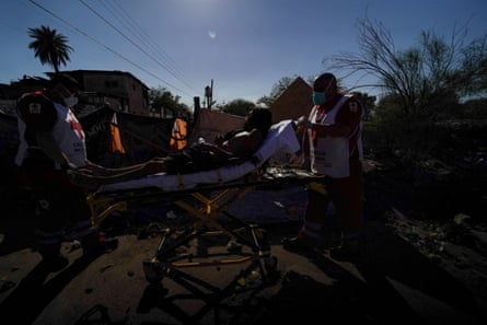 Red Cross paramedics wheel a homeless man showing symptoms of heat exhaustion to an ambulance during the ongoing heatwave in Mexicali, Mexico, on 20 July 2023.