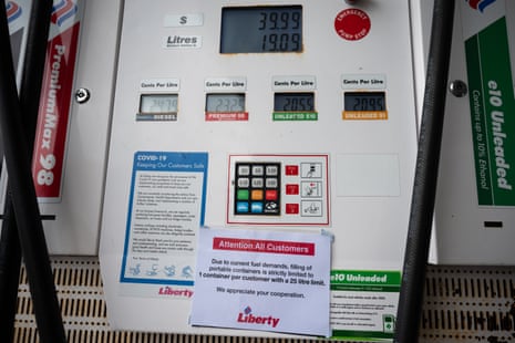 Australia news live: household confidence dips as RBA expected to raise cash rate; regulator summons fuel giants over prices | Australia news 3 A notice on a petrol station