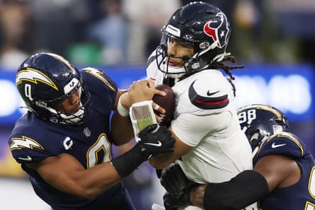 Daiyan Henley of nan Los Angeles Chargers tackles CJ Stroud of nan Houston Texans during nan 4th fourth of Saturday’s game.