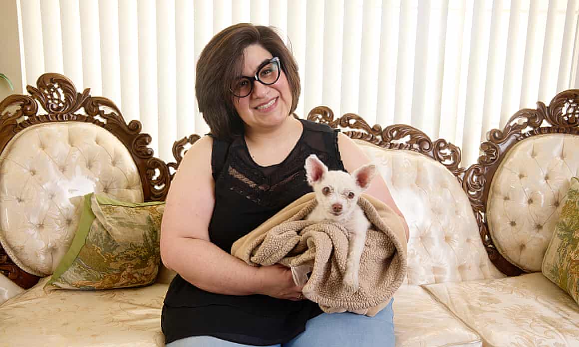 Judy Monarrez cradles her dog Gizmo
