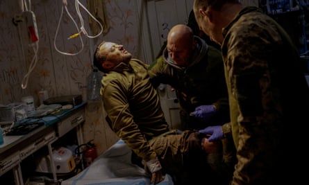 Medics of the 5th Separate Assault Brigade help injured Ukrainian serviceman Mykhailo, 42, inside a medical stabilisation point, near the frontline in the Donetsk region, 9 November
