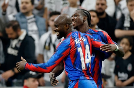 Jean-Philippe Mateta and Jaydee Canvot smile and embrace celebrating a goal on the pitch