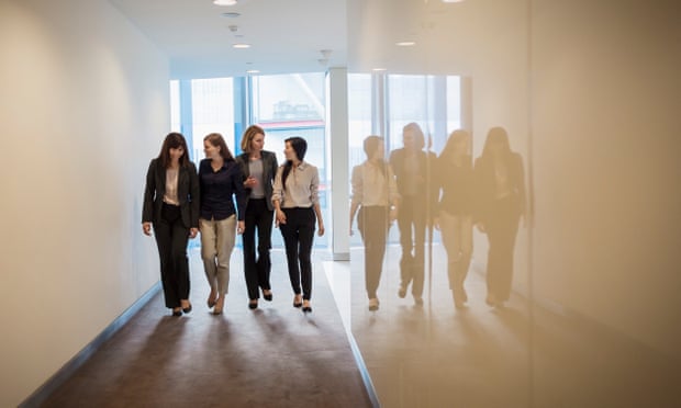 Businesswomen walking in a row in office