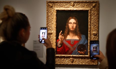 People take pictures of Leonardo da Vinci’s Salvator Mundi.