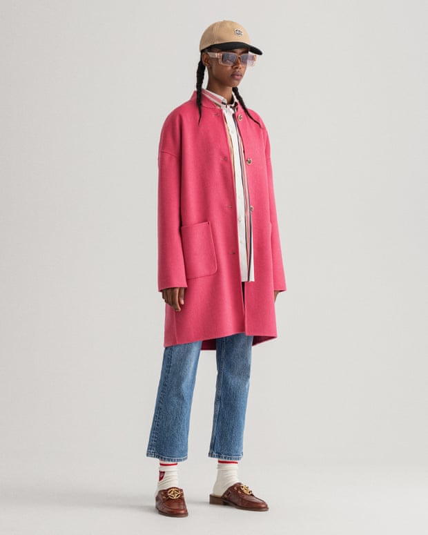 Model wearing spring 2022’s most stylish colour, Gant hot pink coat with denim