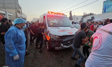 Palestinians pull an ambulance after a convoy of ambulances was hit near the entrance of al-Shifa hospital in Gaza City on Friday