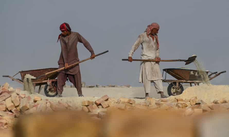 Labourers working at a brick kiln factory in the heat on 12 May.