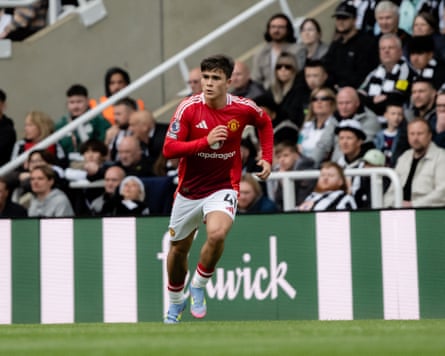 Harry Amass playing for Manchester United with Newcastle fans in the background