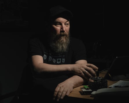 Robert Brovdi wearing black sitting at a table
