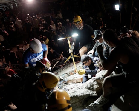 Rescuers work at the site of a collapsed building in Cali, western Colombia, on Monday evening