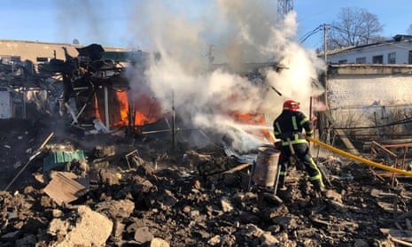 A firefighter works at a site of a market hit by Russian missiles, amid Russia’s attack on Ukraine, in the town of Shevchenkove, Kharkiv region, Ukraine January 9, 2023.