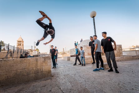 Teenagers do parkour on the Galizia roofs