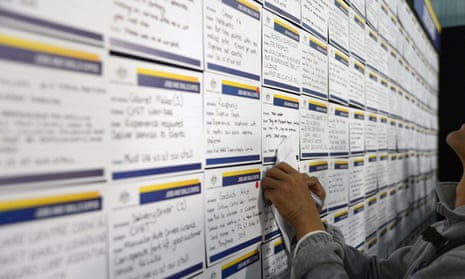 A job seeker takes notes as he browses job notices at a jobs and skills expo run by the Australian government