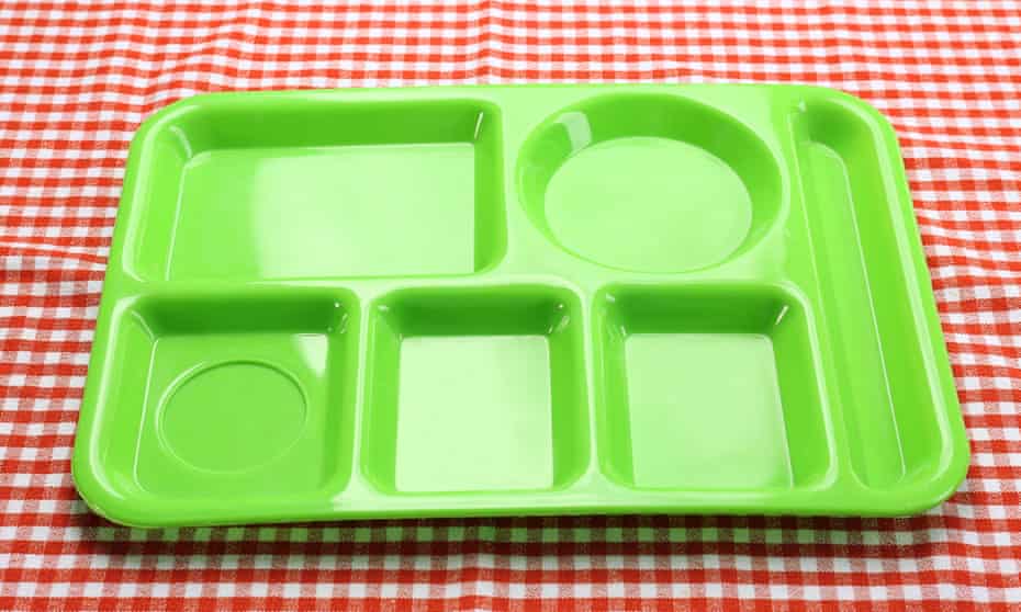 Empty green food tray placed on a red gingham cloth