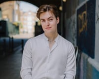Tenor Laurence Kilsby, a rising singing star, pictured wearing a white shirt smiling at the camera.