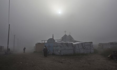 Migrants arrive to attend the final service at a makeshift church in what remains of the Calais camp.