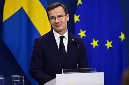 Ulf Kristersson standing at a podium giving a speech