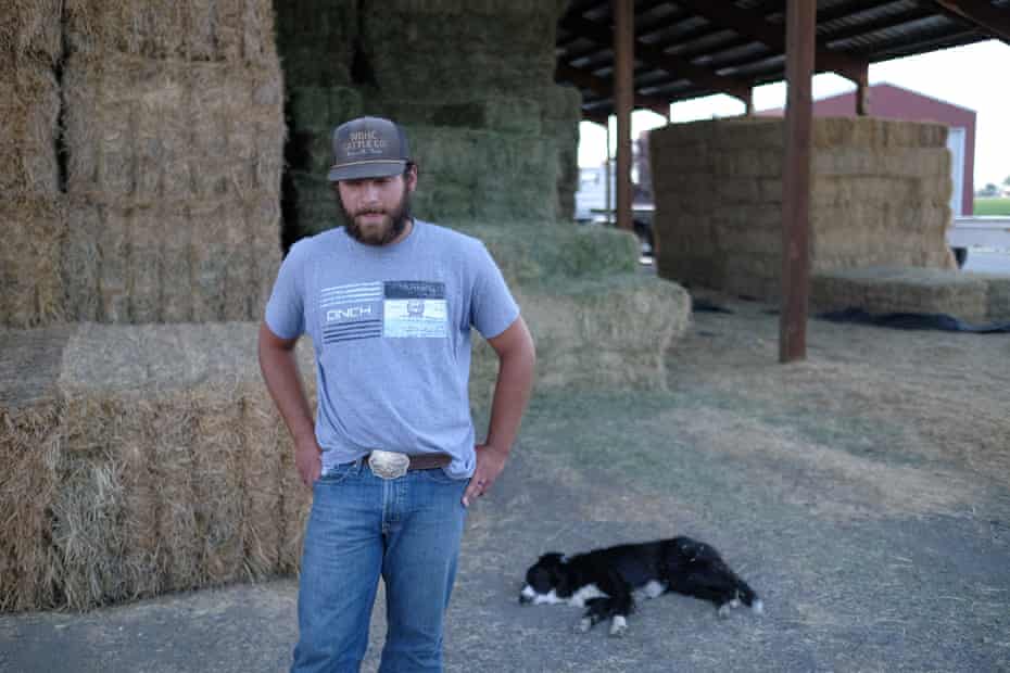 Chance Thompson works for Rodney Cheyne outside Klamath Falls. His dog Deets sleeps on the ground behind him.