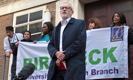 Jeremy Corbyn is joined by porters and cleaning staff during a speech outside Soas University of London.