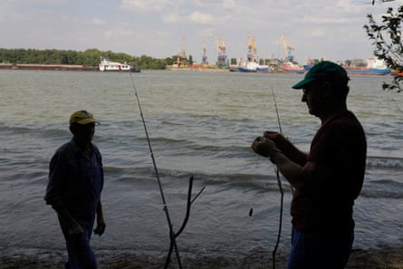 Two men prepare to fish just 500 metres across the Danube from Izmail, in Plauru, Romania.