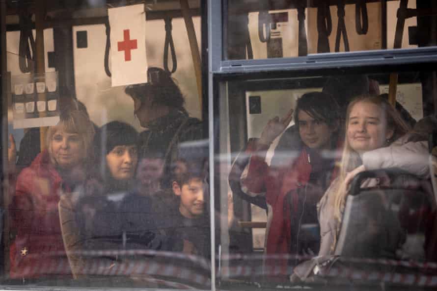 Evacuees including some from the Azovstal plant wave as they arrive on a bus at an evacuation point for people in Zaporizhzhia, Ukraine.
