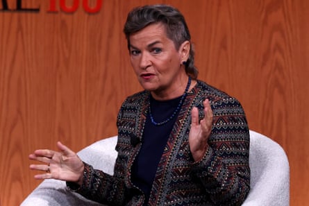 Figueres gestures as she sits on a chair on stage