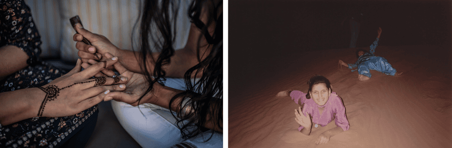 Close up of woman adding henna to another woman's hand, family portrait of two girls laying in sand