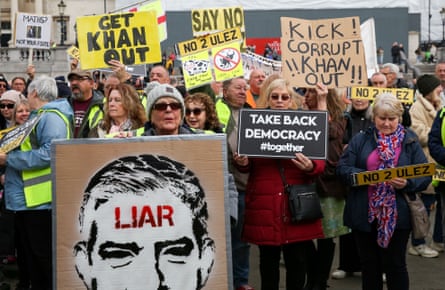 Protesters hold signs expressing their opinions during the demonstration against ULEZ (Ultra Low Emission Zone) expansion in Trafalgar Square, central London, 15 April 2023