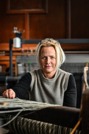 Kelly MacDonald sits behind a weaving loom