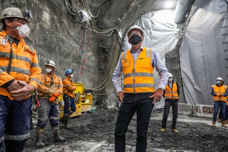 Dan Andrews in mask and safety gear inspecting a rail tunnel under construction