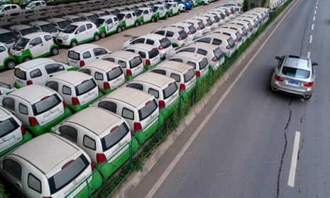 Electric vehicles in a parking lot under a viaduct in Wuhan, central China’s Hubei province. Beijing is encouraging drivers to buy electric as it attempts to tackle the country’s smog problems.