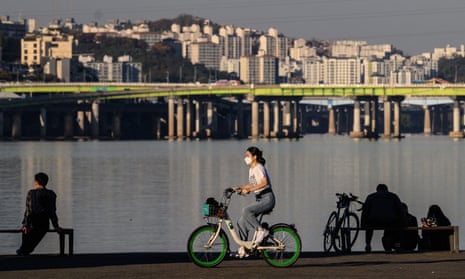 woman rides a bike in seoul