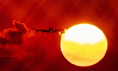 An aircraft passes the sun as the annual average global temperature is expected to increase.