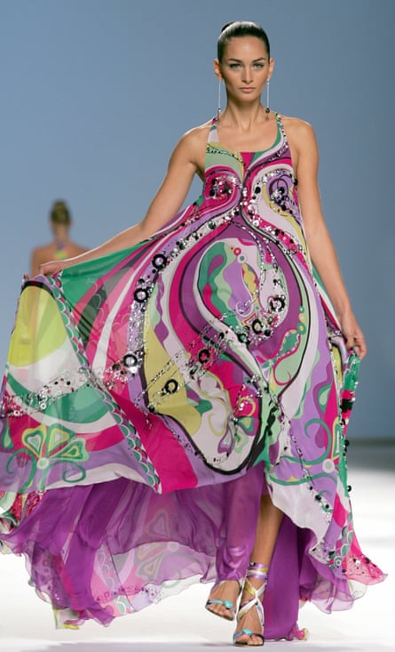 Model walks the runway in a vibrant, brightly coloured dress