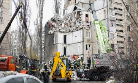 Employees of the State Emergency Service sort through the rubble of a residential building partially destroyed due to a drone attack by Russian military on March 2, 2024 in Odesa.