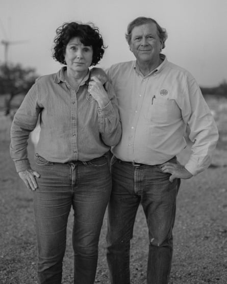 black and white portrait of a woman and man in button down shirts and jeans outside
