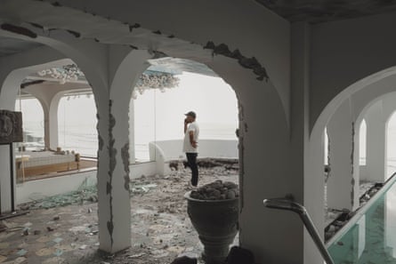 Komang Agus, the manager of Morabito Art Cliff villa, standing amid the rubble.