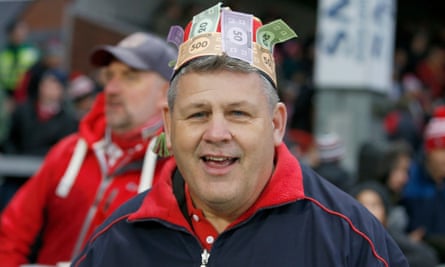 A Gloucester fan with Monopoly money attached to his hat mocks the Saracens salary cap scandal on Saturday.